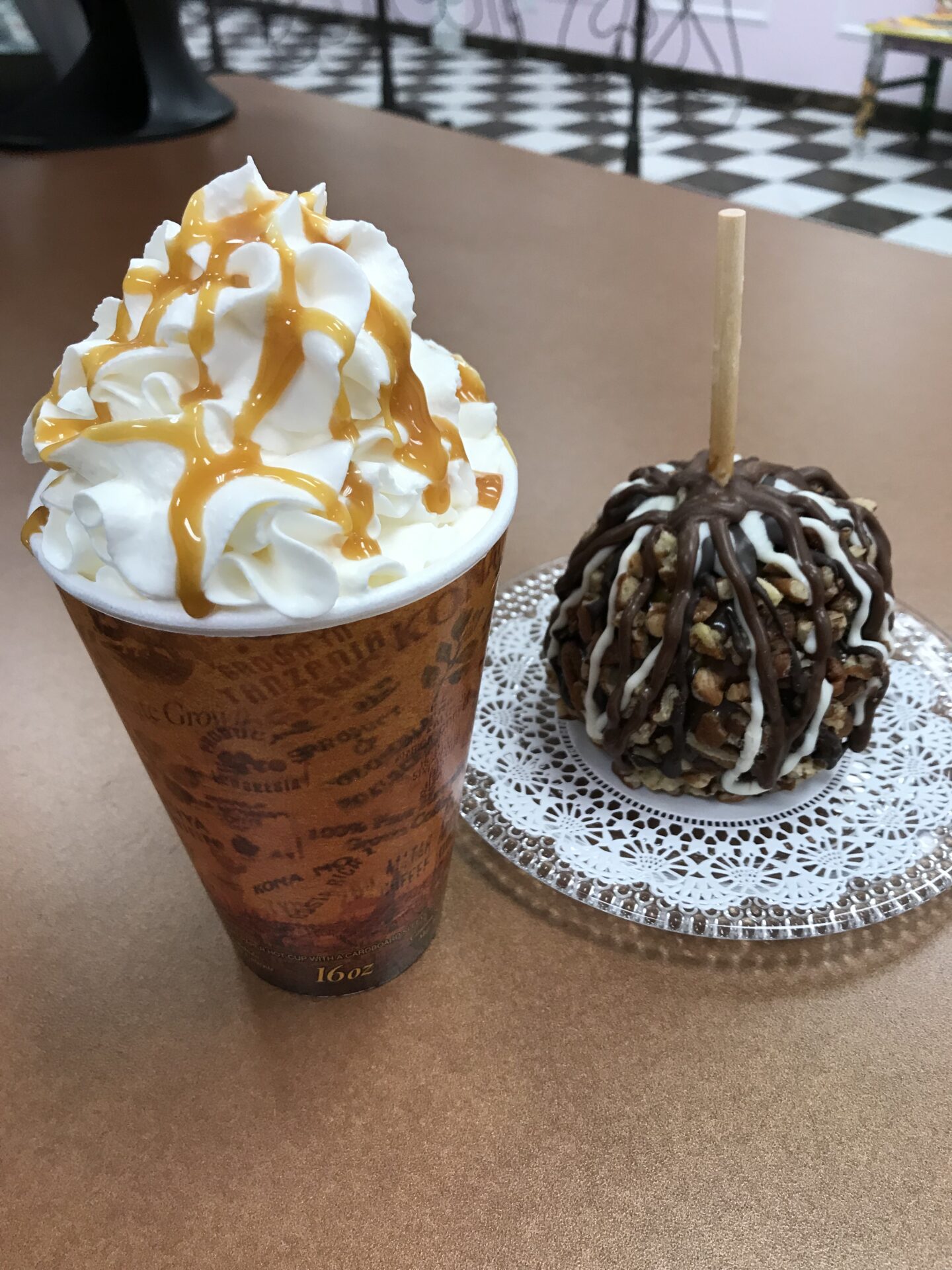 A cup of frappe and a candied apple